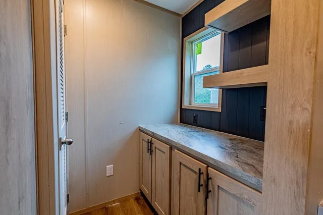 a view of kitchen cabinets window and wooden floor