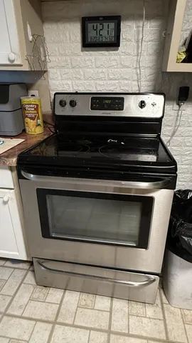a stove top oven sitting inside of a kitchen