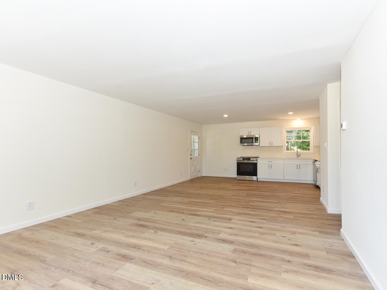 939 Cheves Road Zebulon, NC 27597 - Photo 9 of 21 a view of a big room with wooden floor and kitchen
