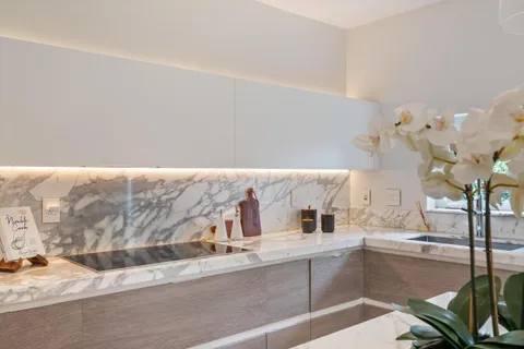 a kitchen with a sink and natural light