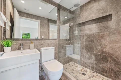 a bathroom with a sink toilet and shower