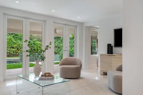 a living room with furniture and a potted plant