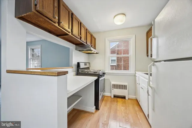 a kitchen with stainless steel appliances a stove a sink and a refrigerator