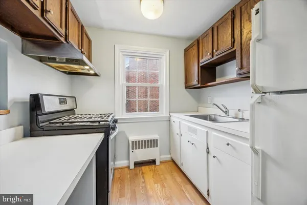 a kitchen with stainless steel appliances granite countertop a stove and a sink