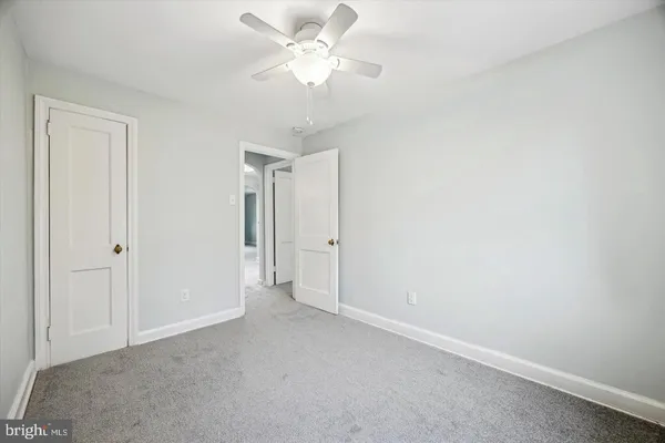 a view of a big room with chandelier fan