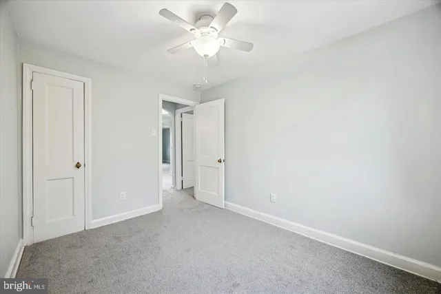 a view of a big room with chandelier fan