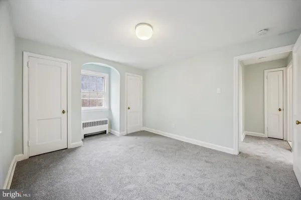 a view of an empty room and closet area