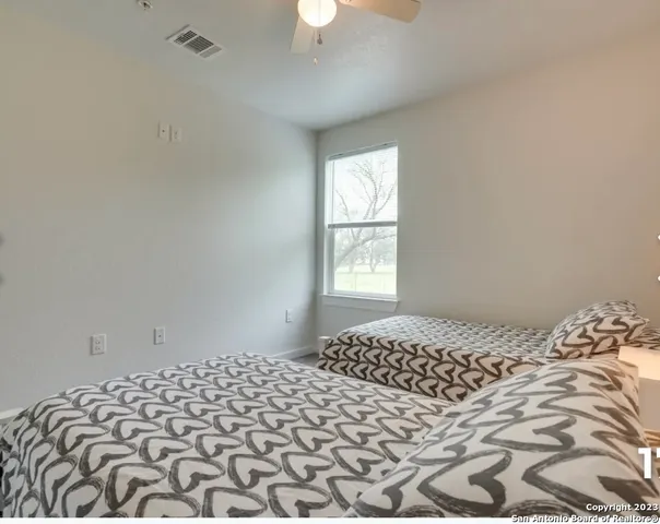 a bedroom with a bed and a window