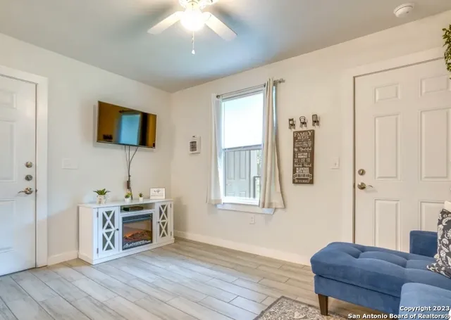 a living room with furniture and a flat screen tv