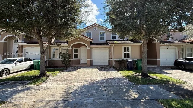 a front view of a house with yard patio and fire pit