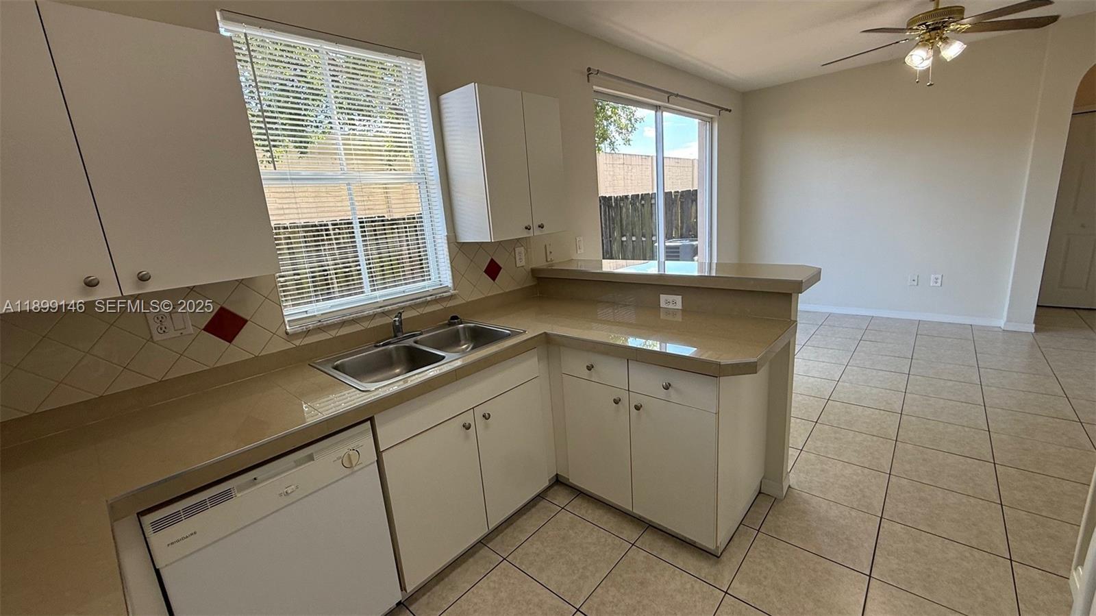 13810 Southwest 276th Street, Unit 13810 Homestead, FL 33032 - Photo 14 of 38 a view of a kitchen with a sink and cabinets