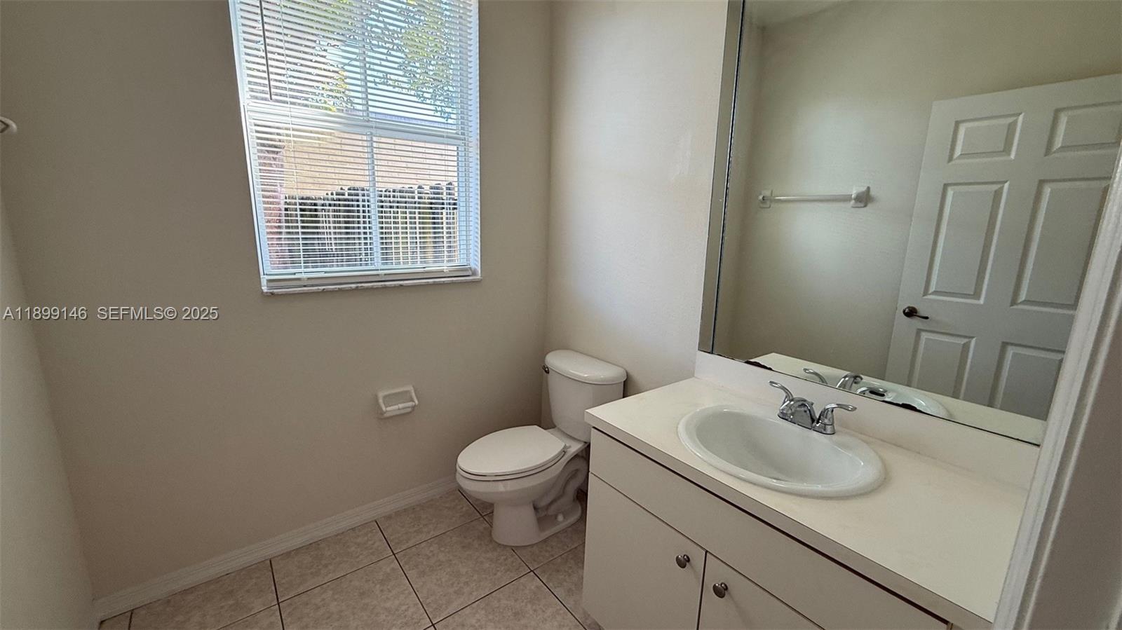 13810 Southwest 276th Street, Unit 13810 Homestead, FL 33032 - Photo 17 of 38 a bathroom with a sink toilet and window