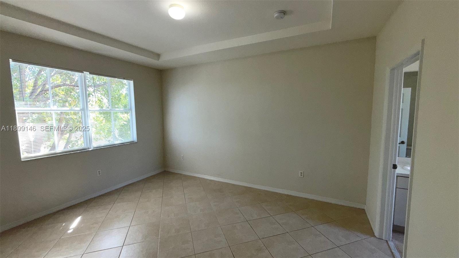 13810 Southwest 276th Street, Unit 13810 Homestead, FL 33032 - Photo 18 of 38 an empty room with windows