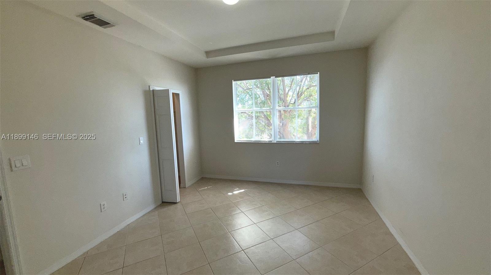 13810 Southwest 276th Street, Unit 13810 Homestead, FL 33032 - Photo 20 of 38 an empty room with windows