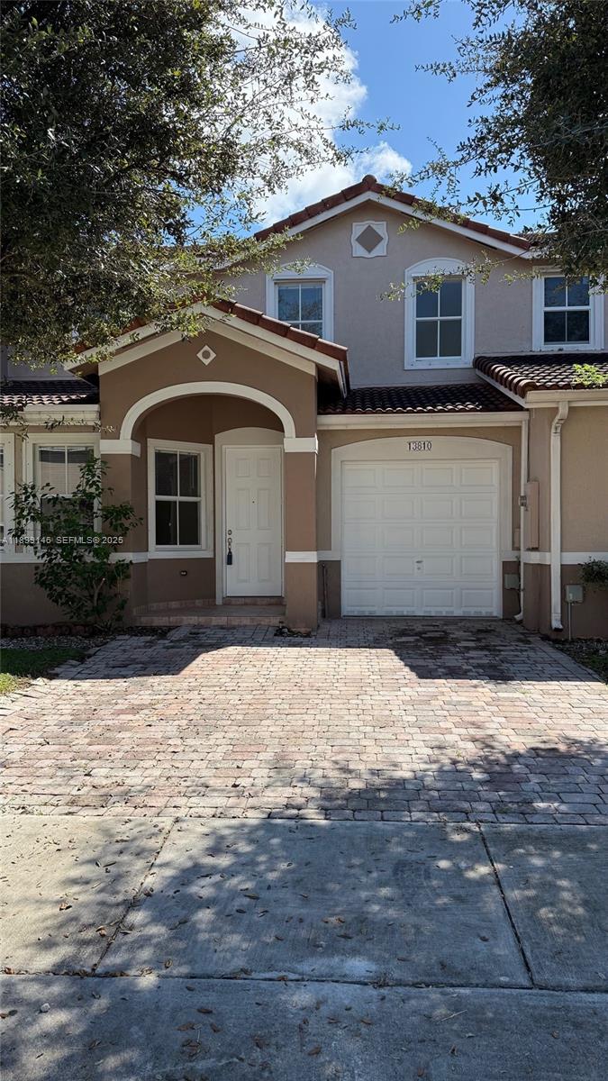 13810 Southwest 276th Street, Unit 13810 Homestead, FL 33032 - Photo 2 of 38 a front view of a house with yard