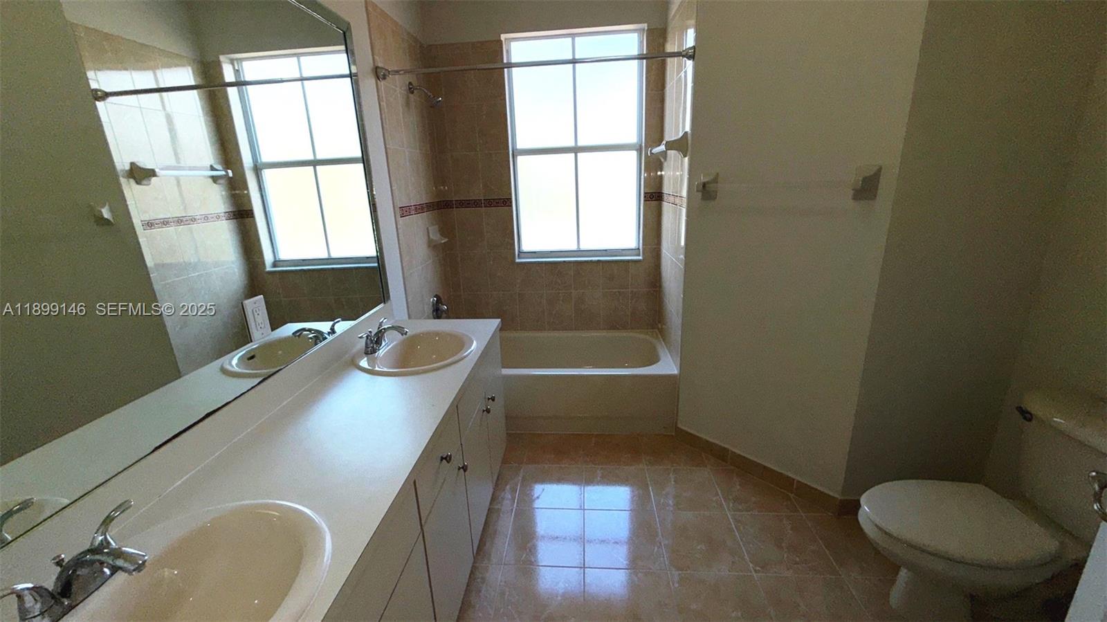 13810 Southwest 276th Street, Unit 13810 Homestead, FL 33032 - Photo 21 of 38 a bathroom with a sink toilet and tub