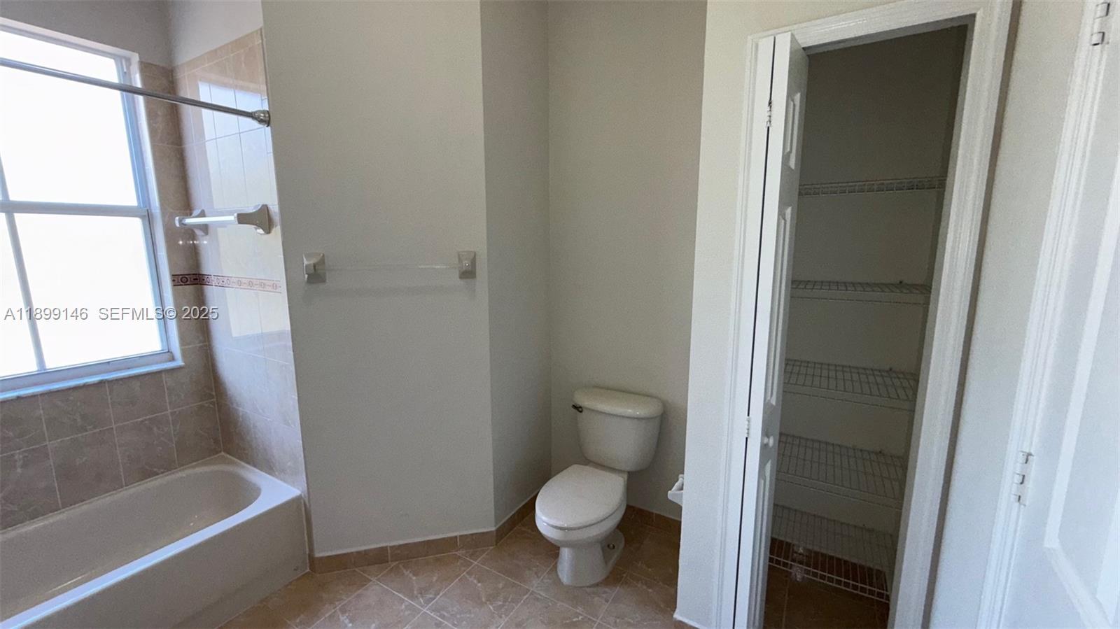 13810 Southwest 276th Street, Unit 13810 Homestead, FL 33032 - Photo 22 of 38 a white toilet sitting next to a bath tub