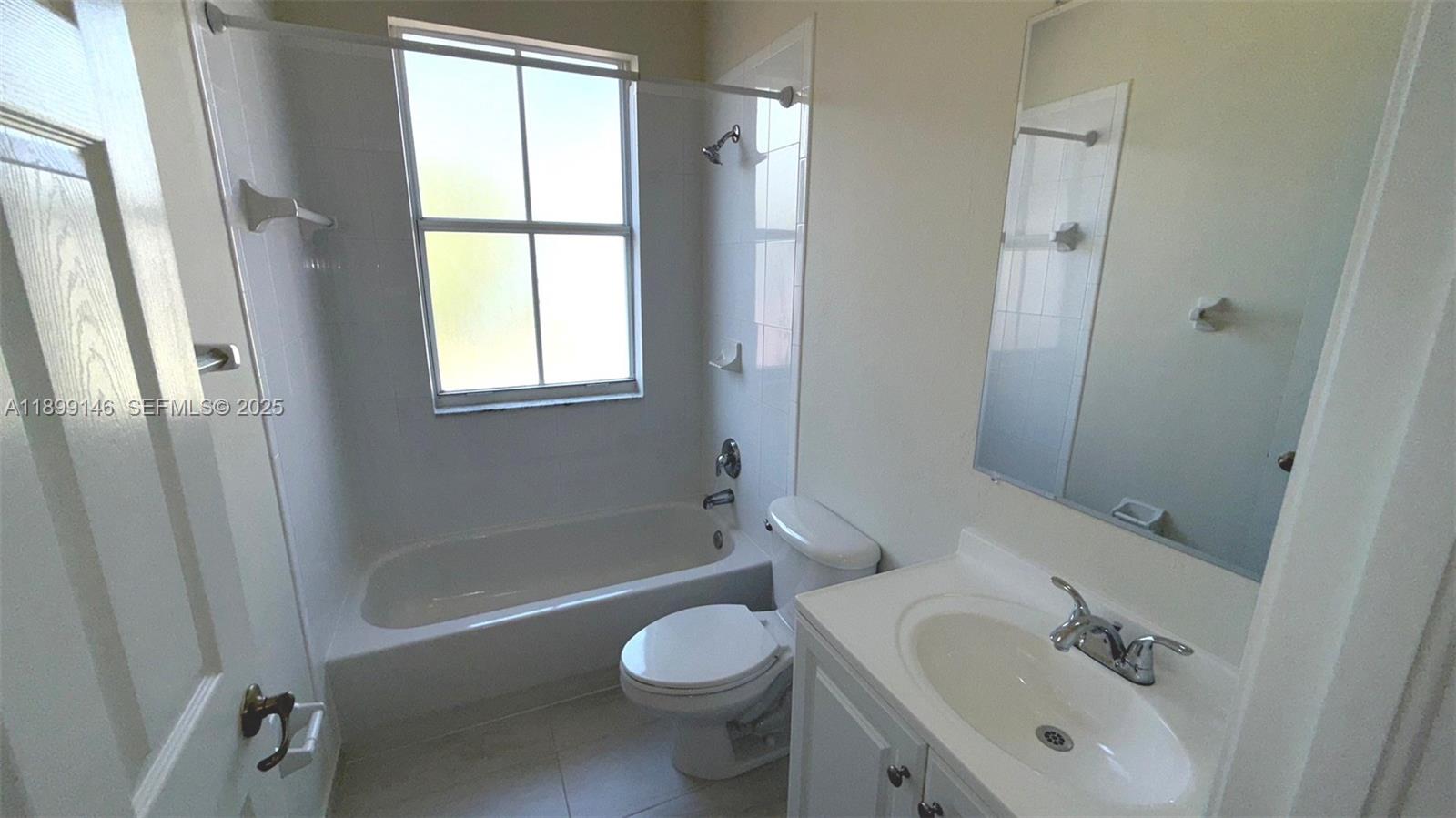 13810 Southwest 276th Street, Unit 13810 Homestead, FL 33032 - Photo 27 of 38 a bathroom with a sink toilet and shower