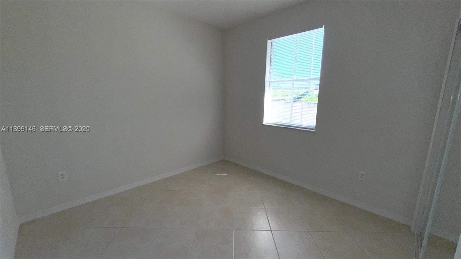 13810 Southwest 276th Street, Unit 13810 Homestead, FL 33032 - Photo 28 of 38 an empty room with a window