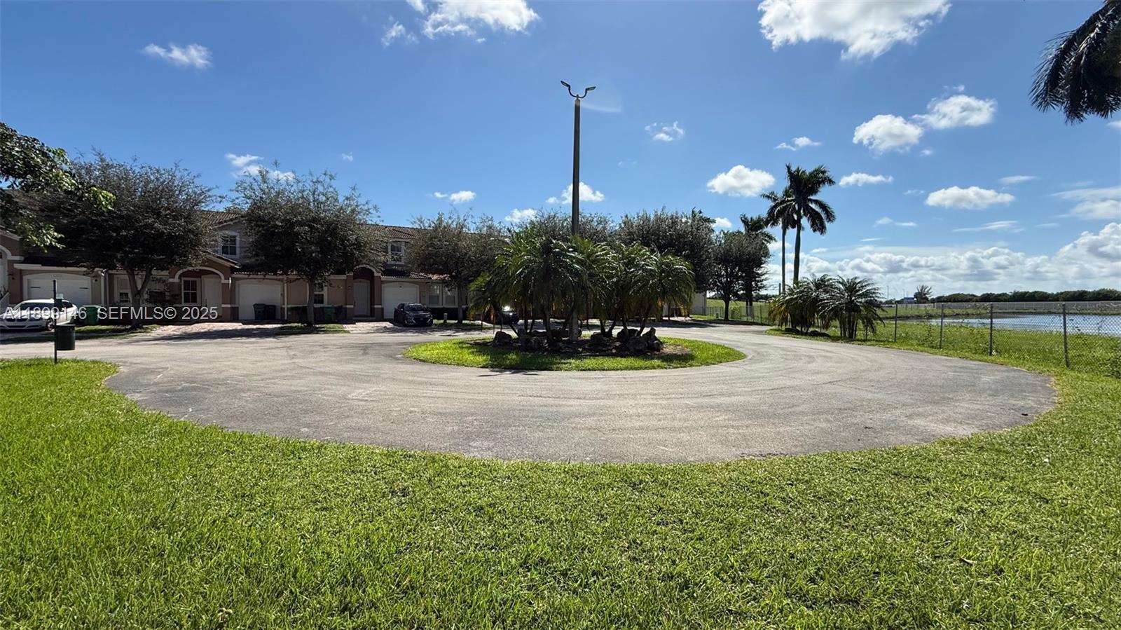 13810 Southwest 276th Street, Unit 13810 Homestead, FL 33032 - Photo 3 of 38 a view of a park with large trees