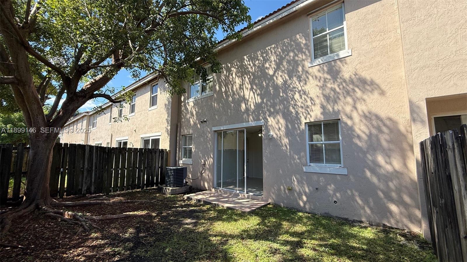 13810 Southwest 276th Street, Unit 13810 Homestead, FL 33032 - Photo 35 of 38 a backyard of a house with lots of green space