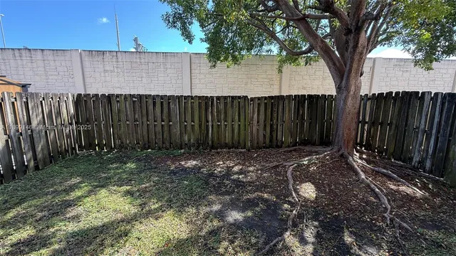 a view of outdoor space with wooden fence