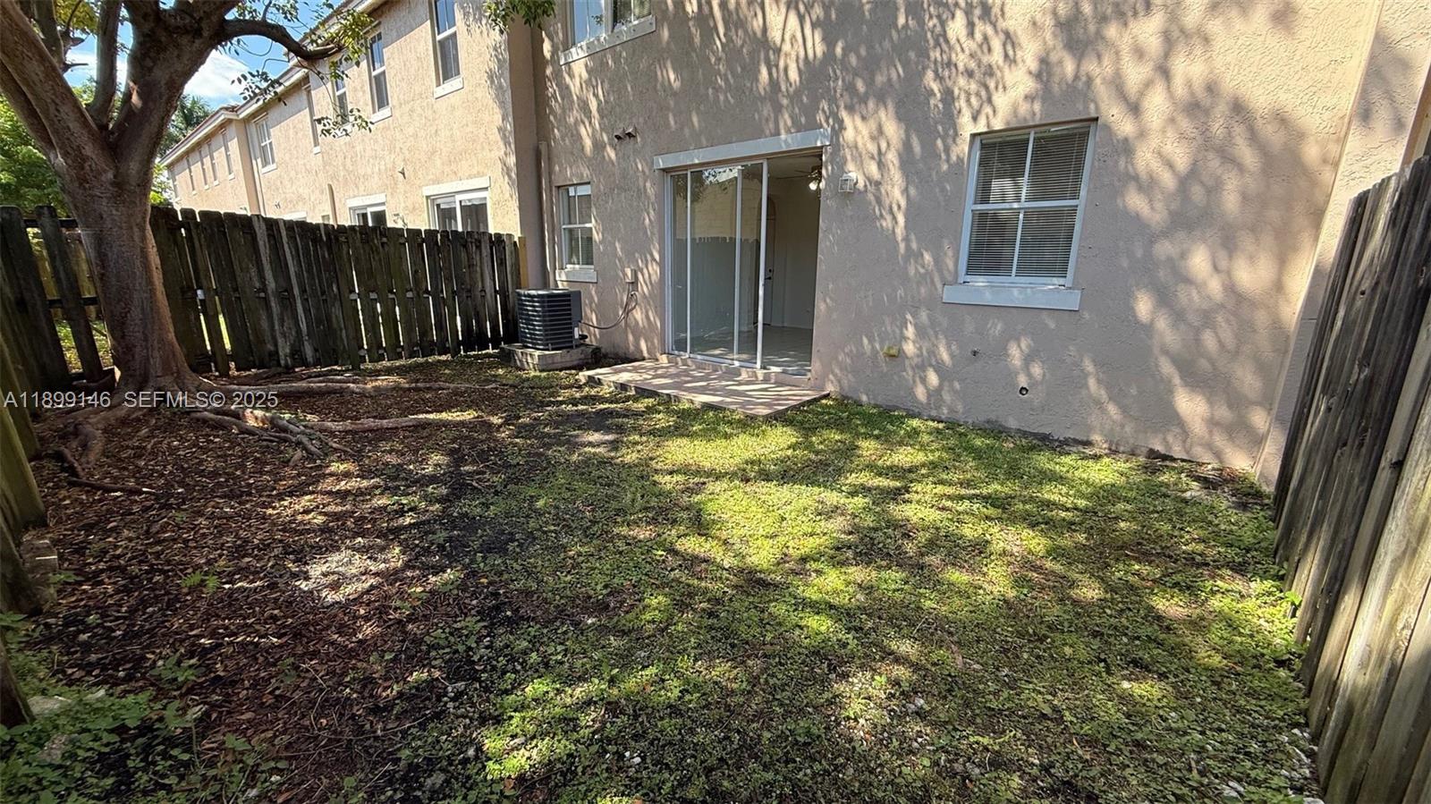 13810 Southwest 276th Street, Unit 13810 Homestead, FL 33032 - Photo 37 of 38 a view of a backyard with a tree