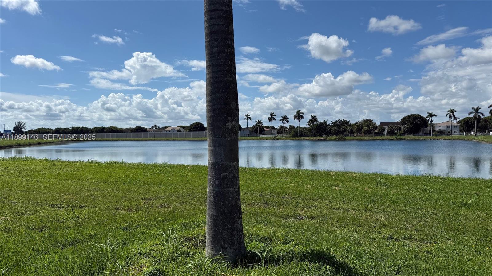 13810 Southwest 276th Street, Unit 13810 Homestead, FL 33032 - Photo 4 of 38 a view of a lake from a yard
