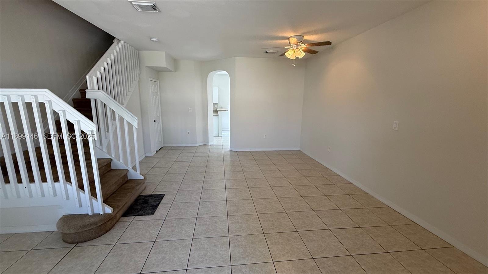 13810 Southwest 276th Street, Unit 13810 Homestead, FL 33032 - Photo 5 of 38 wooden floor in an empty room with a window