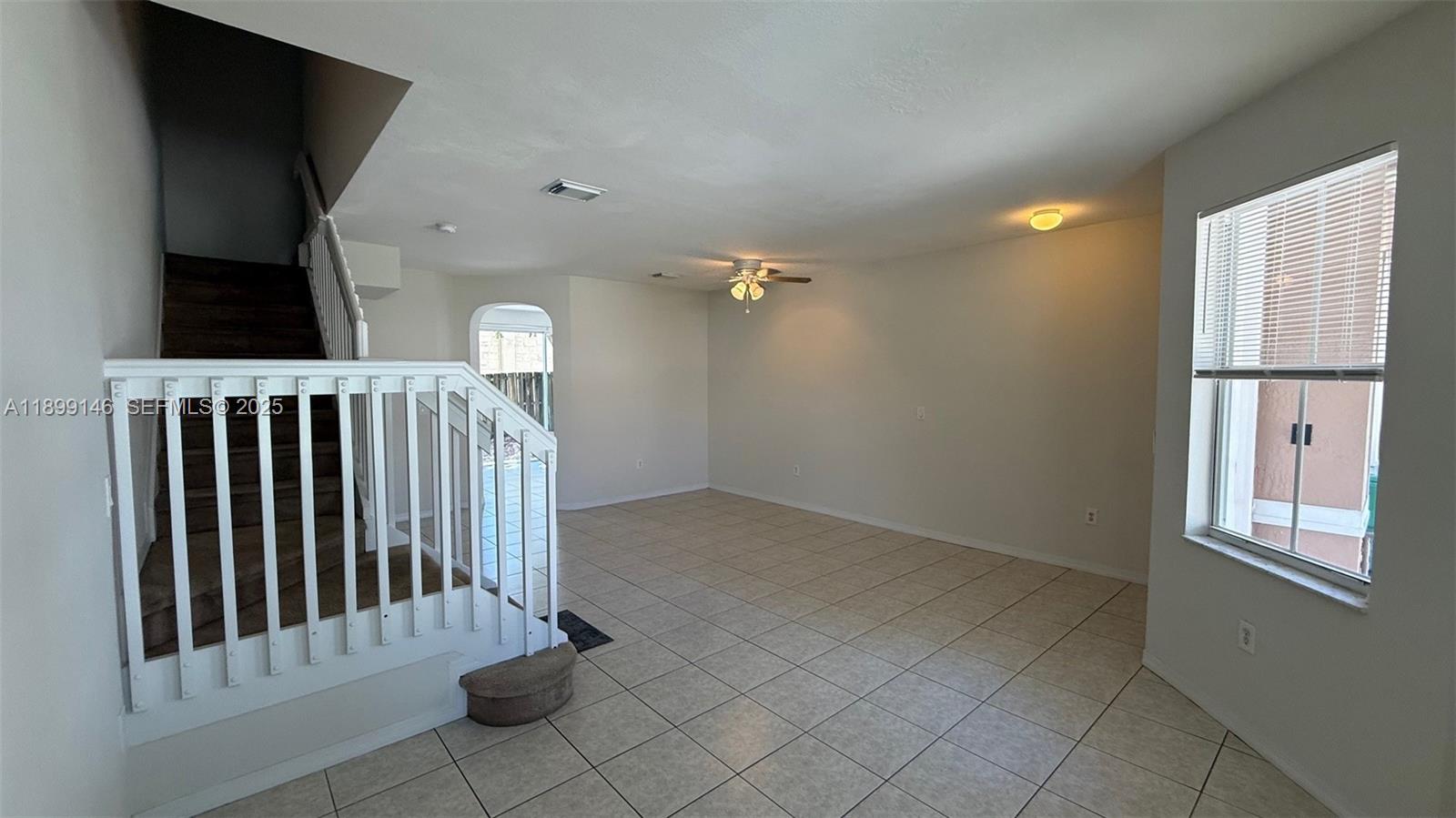 13810 Southwest 276th Street, Unit 13810 Homestead, FL 33032 - Photo 6 of 38 a view of an empty room with a window