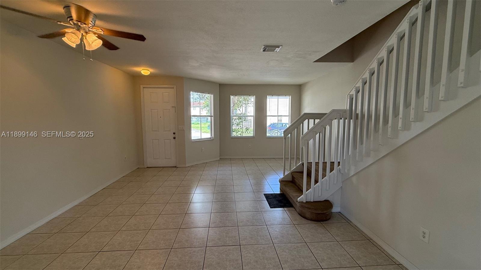 13810 Southwest 276th Street, Unit 13810 Homestead, FL 33032 - Photo 7 of 38 a view of an entryway with wooden floor and livingroom view