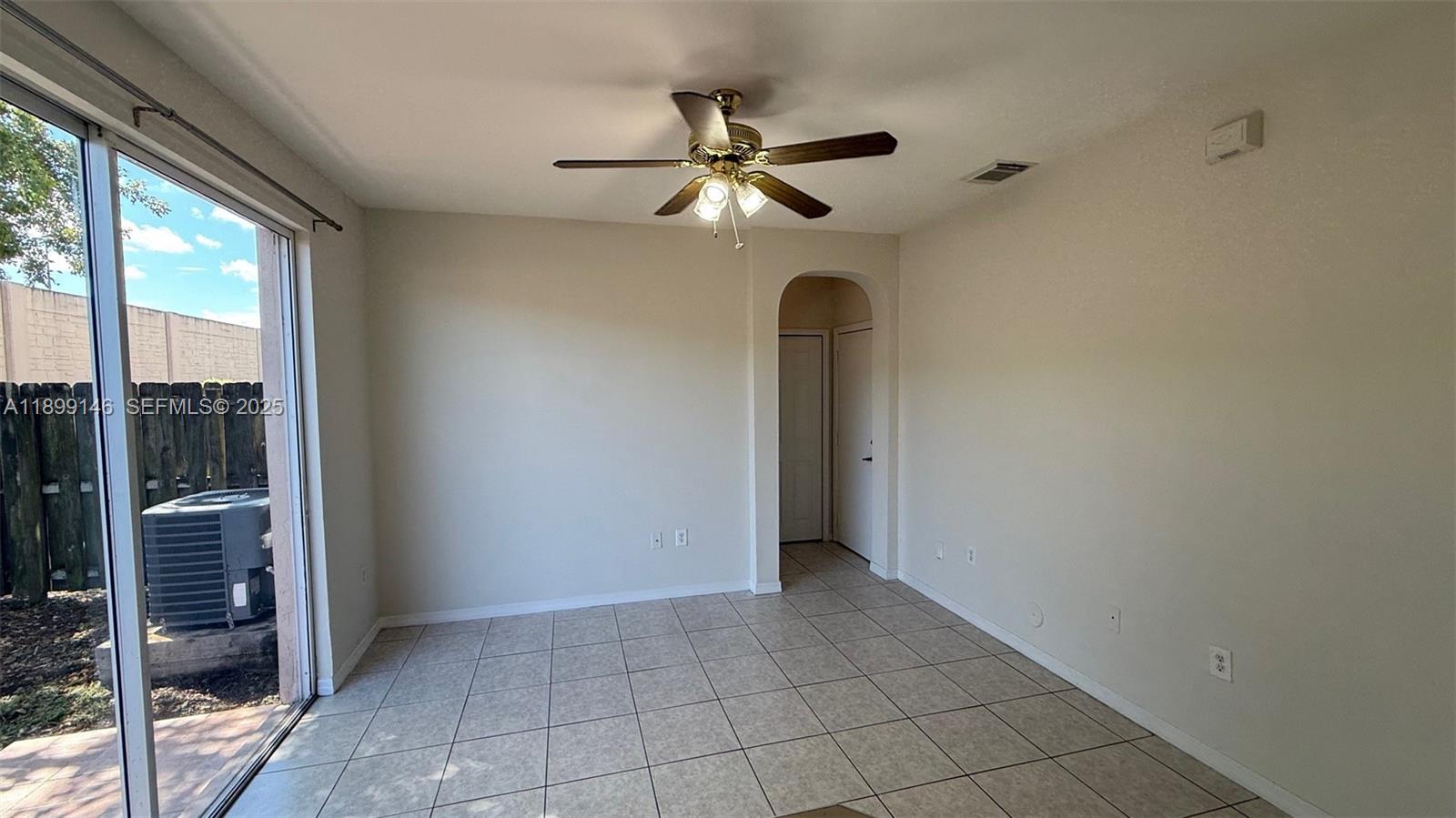 13810 Southwest 276th Street, Unit 13810 Homestead, FL 33032 - Photo 9 of 38 a view of an empty room and window