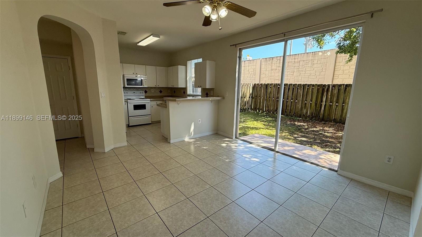 13810 Southwest 276th Street, Unit 13810 Homestead, FL 33032 - Photo 10 of 38 a view of a kitchen with a sink dishwasher and a refrigerator