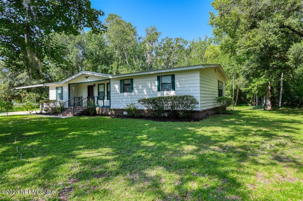 2221 Twin Fox Trail St. Augustine, FL 32086 - Photo 1 of 36 a front view of a house with a yard and trees