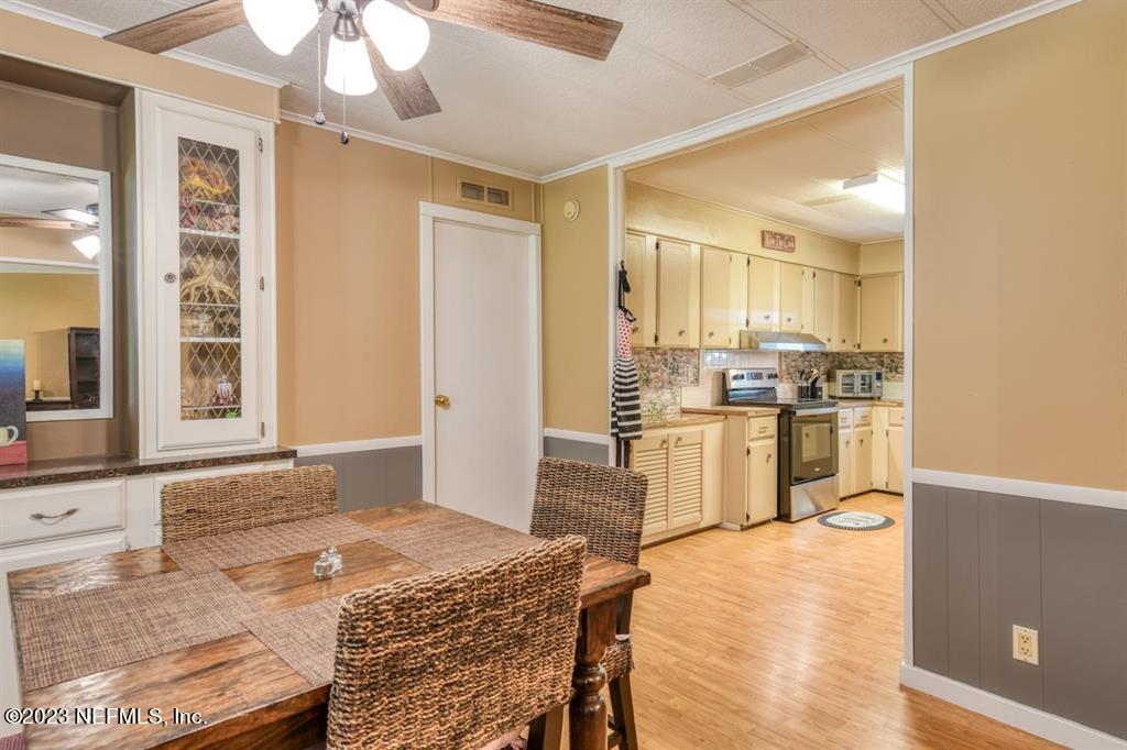 2221 Twin Fox Trail St. Augustine, FL 32086 - Photo 11 of 36 a kitchen with granite countertop a stove refrigerator and microwave