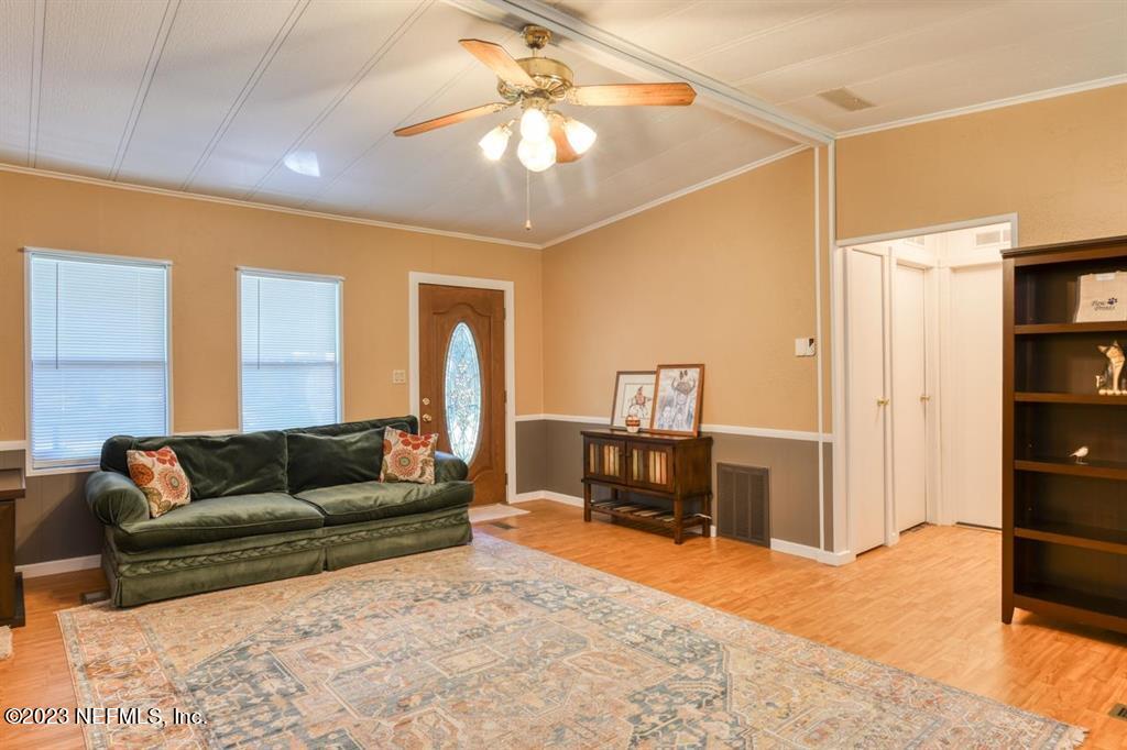2221 Twin Fox Trail St. Augustine, FL 32086 - Photo 12 of 36 a living room with furniture and a dining table with kitchen view