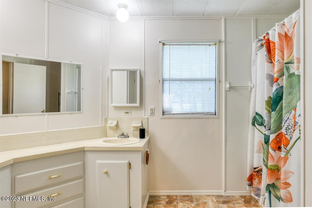 2221 Twin Fox Trail St. Augustine, FL 32086 - Photo 18 of 36 a bathroom with a sink and a mirror