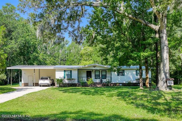 2221 Twin Fox Trail St. Augustine, FL 32086 - Photo 2 of 36 a front view of a house with a garden