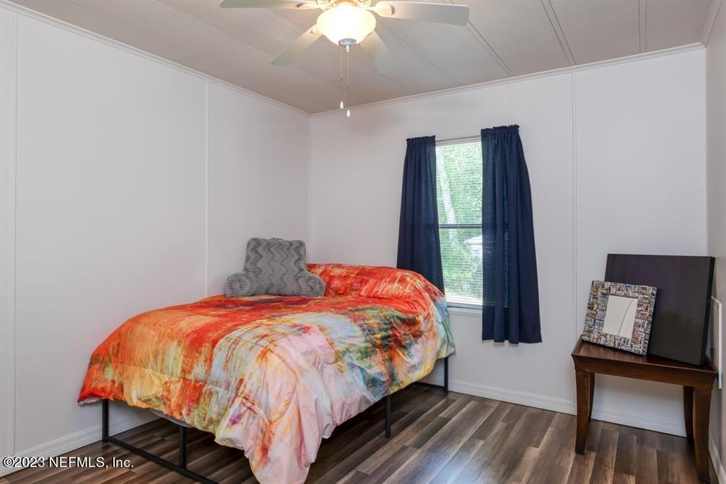 2221 Twin Fox Trail St. Augustine, FL 32086 - Photo 23 of 36 a bed sitting in a bedroom next to a window