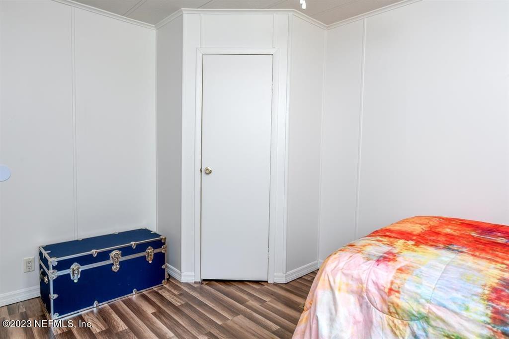 2221 Twin Fox Trail St. Augustine, FL 32086 - Photo 24 of 36 a bedroom with a bed and a dresser