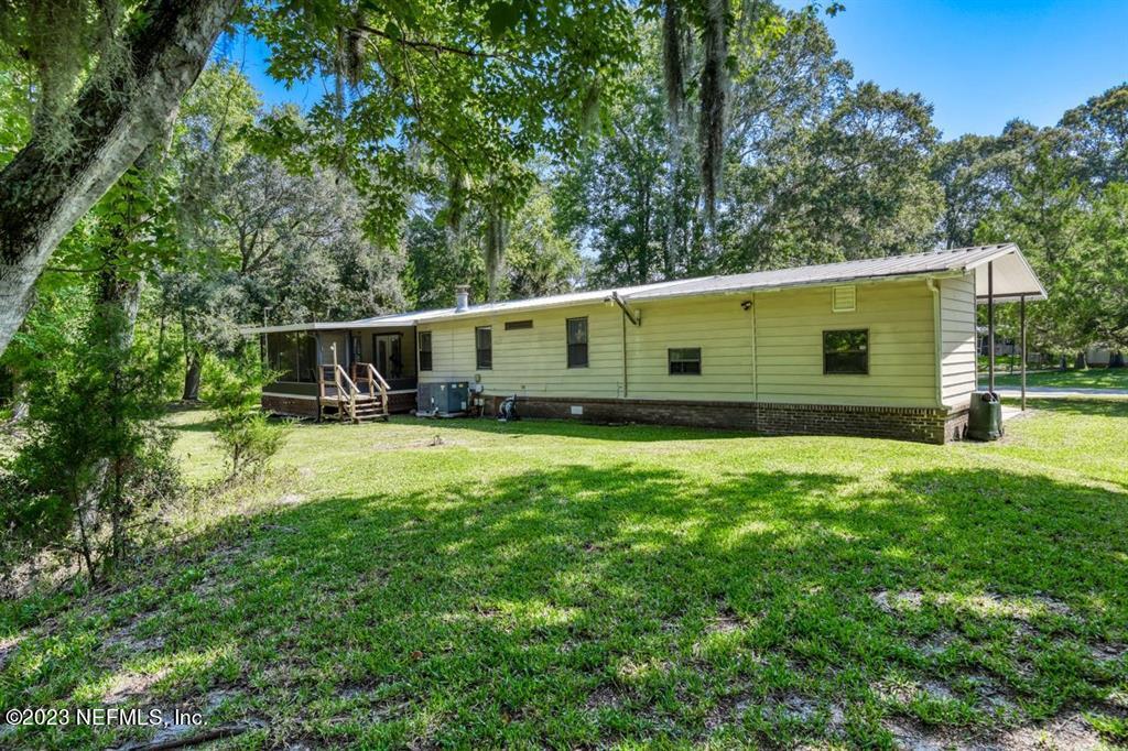 2221 Twin Fox Trail St. Augustine, FL 32086 - Photo 29 of 36 a view of a backyard with plants and a patio