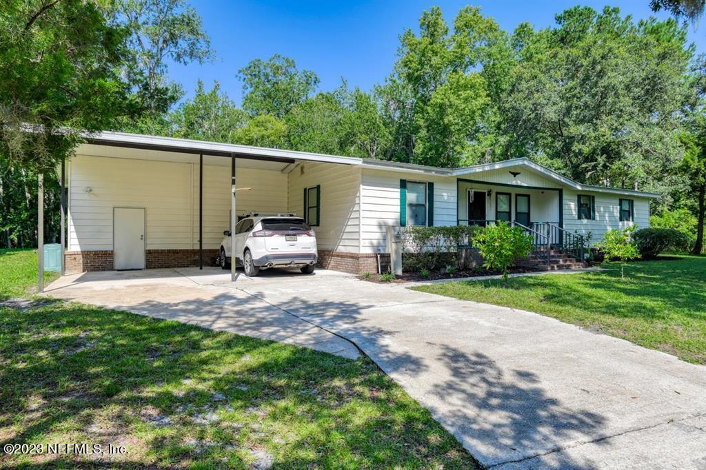 2221 Twin Fox Trail St. Augustine, FL 32086 - Photo 4 of 36 a front view of house with yard and trees in the background