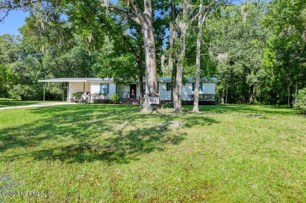 2221 Twin Fox Trail St. Augustine, FL 32086 - Photo 5 of 36 a house view with a sitting space and garden