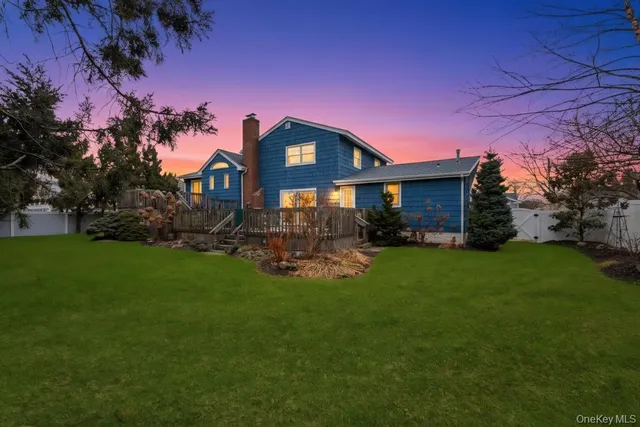 a front view of a house with a yard fire pit and outdoor seating