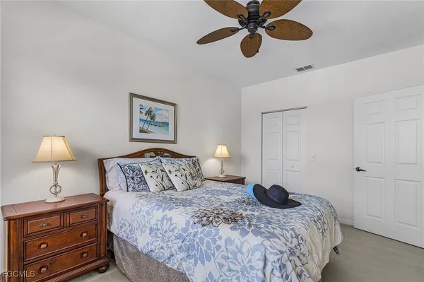 a bedroom with a bed and a lamp