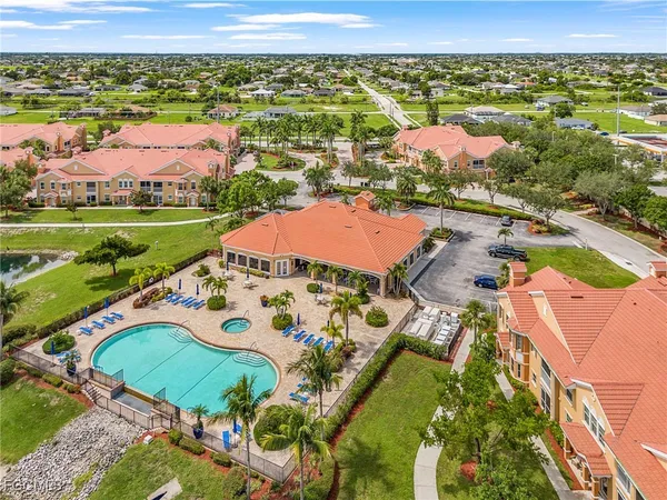 an aerial view of residential houses with outdoor space and swimming pool