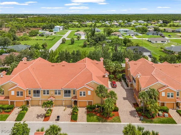 an aerial view of residential houses with outdoor space and street view