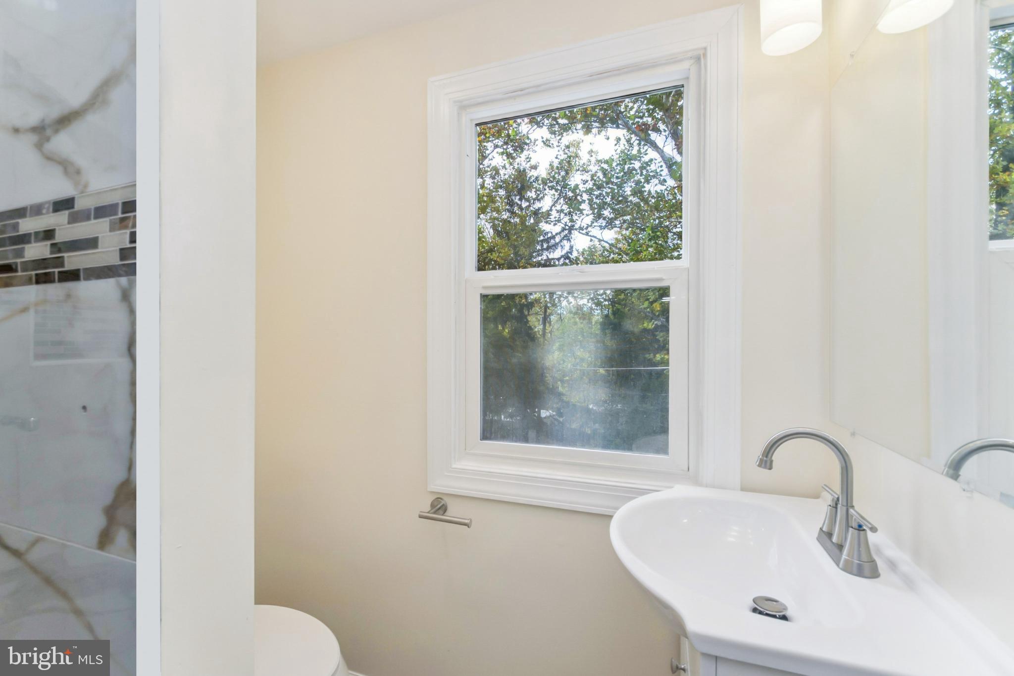 6804 Carol Road Baltimore, MD 21207 - Photo 13 of 25 a bathroom with a sink and a mirror