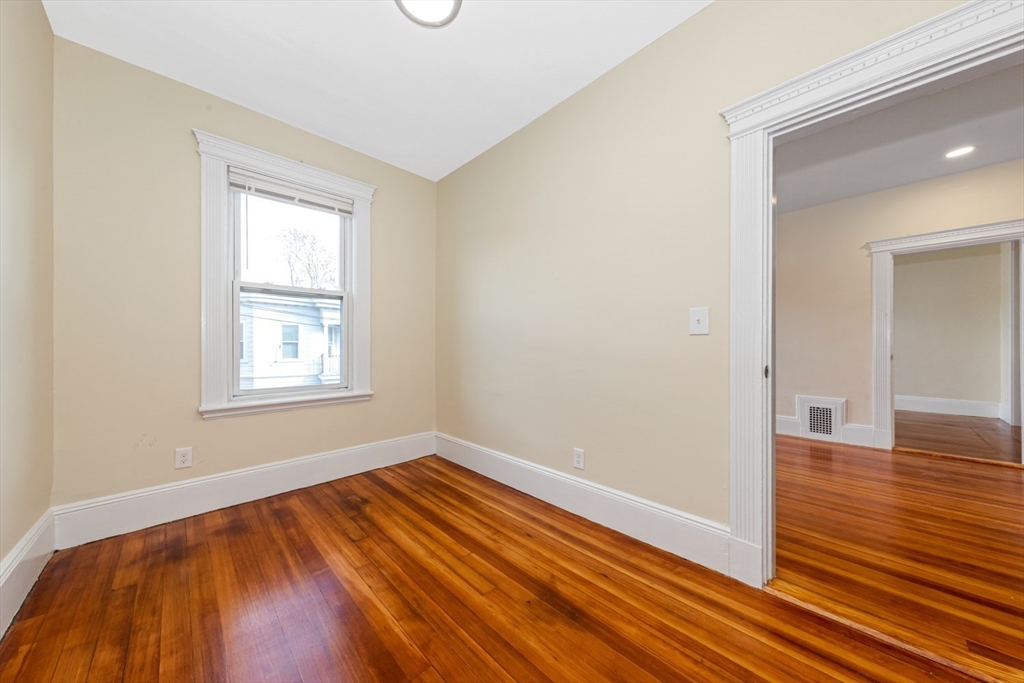 44 Brackett Street, Unit 3 Boston, MA 02135 - Photo 15 of 27 a view of a room with wooden floor and window