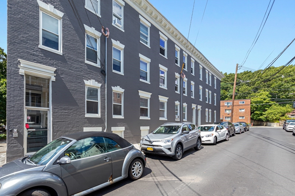 44 Brackett Street, Unit 3 Boston, MA 02135 - Photo 25 of 27 a view of cars parked in front of a building
